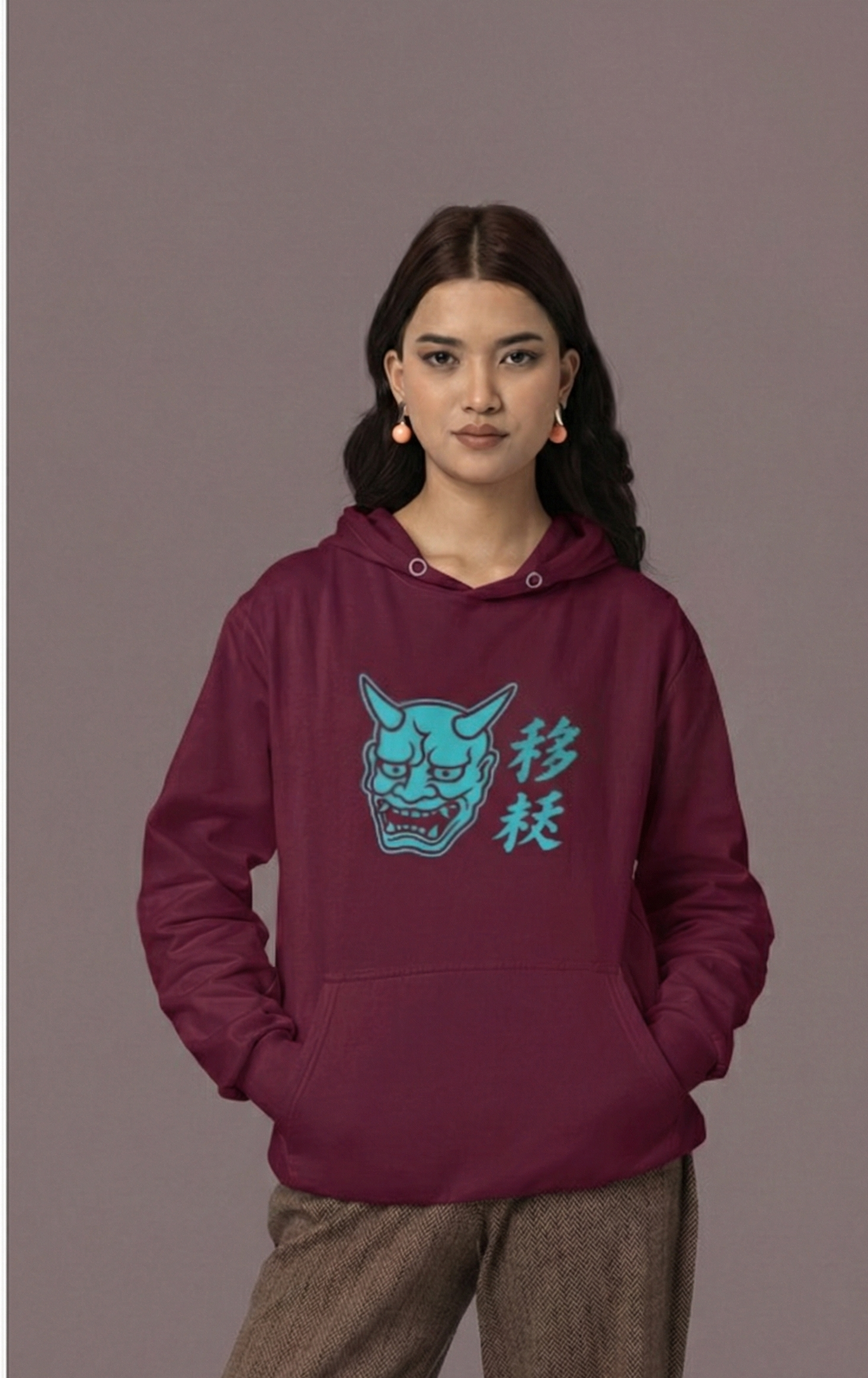 Person wearing a maroon hoodie with a graphic design on a gray background