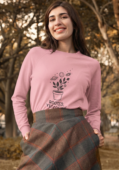 Woman wearing a pink sweatshirt with a plant design outdoors
