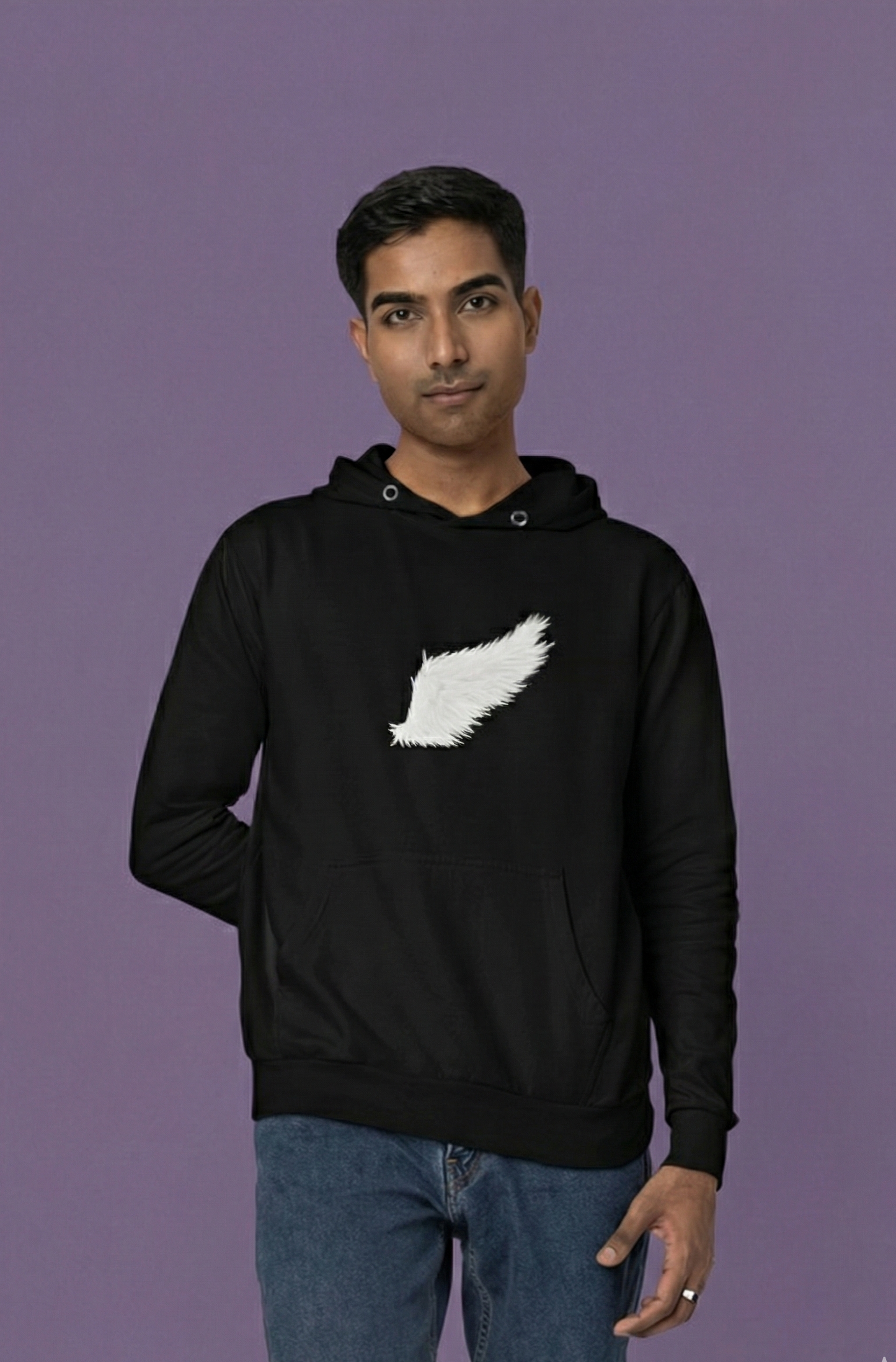 Man wearing a black hoodie with a white logo on a purple background