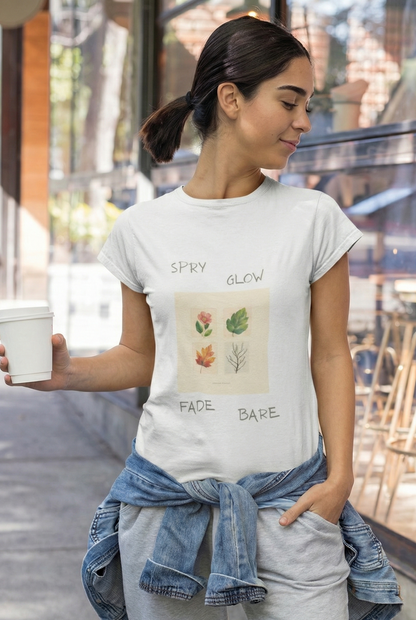 Woman wearing a white t-shirt with a graphic design, holding a coffee cup outdoors.